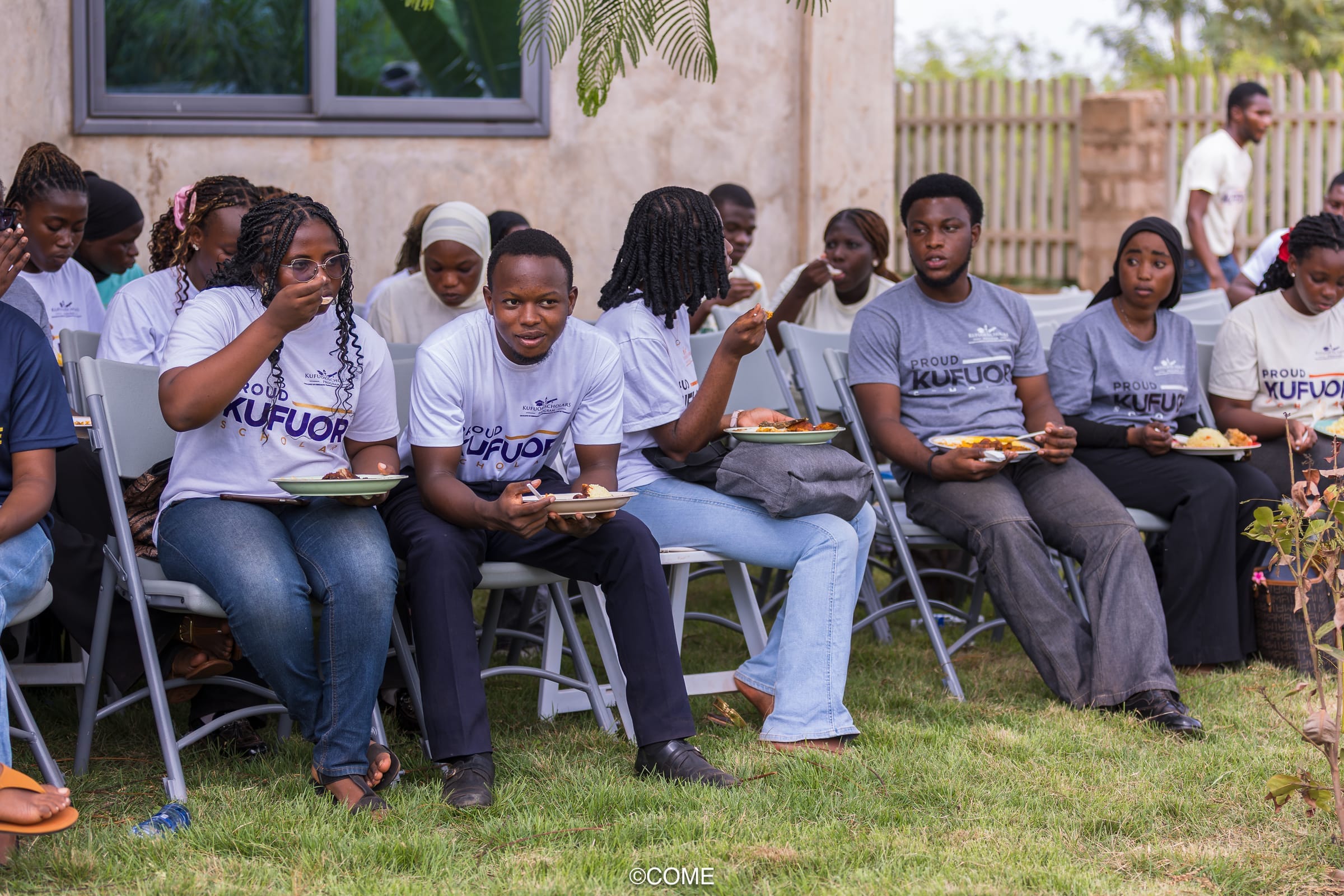 Scholars sharing a meal outdoors